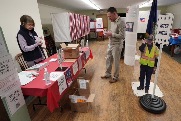 Election worker Barbara Wheelock, left, and town moderator Keith Young count ballots before the polls open for the presidential primary election, Tuesday, Jan. 23, 2024, in the Groveton village of Northumberland, N.H. "We have to make sure we have the same number of ballots at the end of the day as at the beginning," said Young. (AP Photo/Robert F. Bukaty)